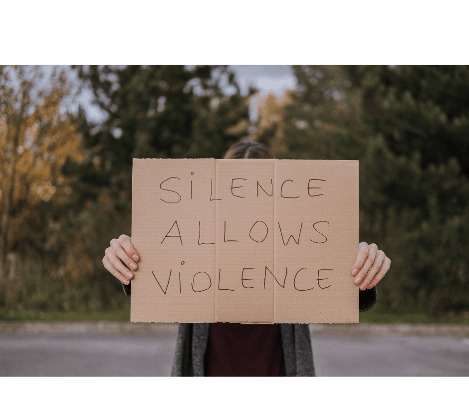 Woman holding a sign that reads "silence allows violence".